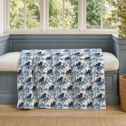Poodle breed toile blanket on a window seat