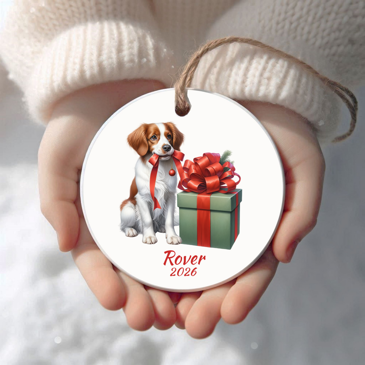 Personalized Brittany Spaniel Christmas ornament held in cupped hands
