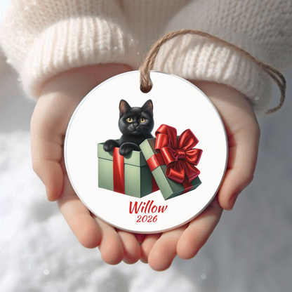 Personalized Black Cat Christmas ornament held in cupped hands