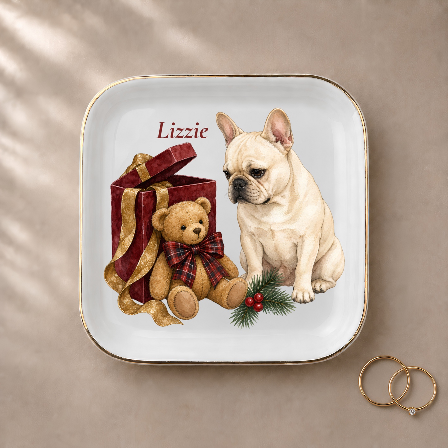 French Bulldog jewelry dish styled with gold rings and a personalized name