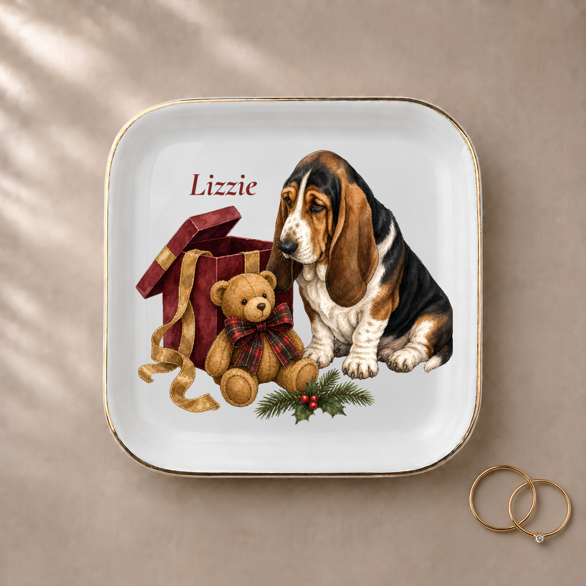 Basset Hound jewelry dish styled with gold rings and a personalized name
