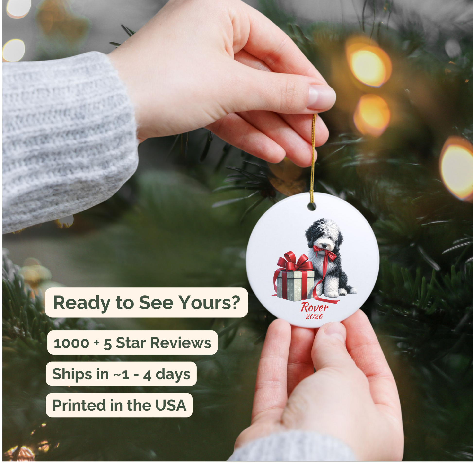 Hand holding a personalized Sheepadoodle ceramic ornament beside a Christmas tree