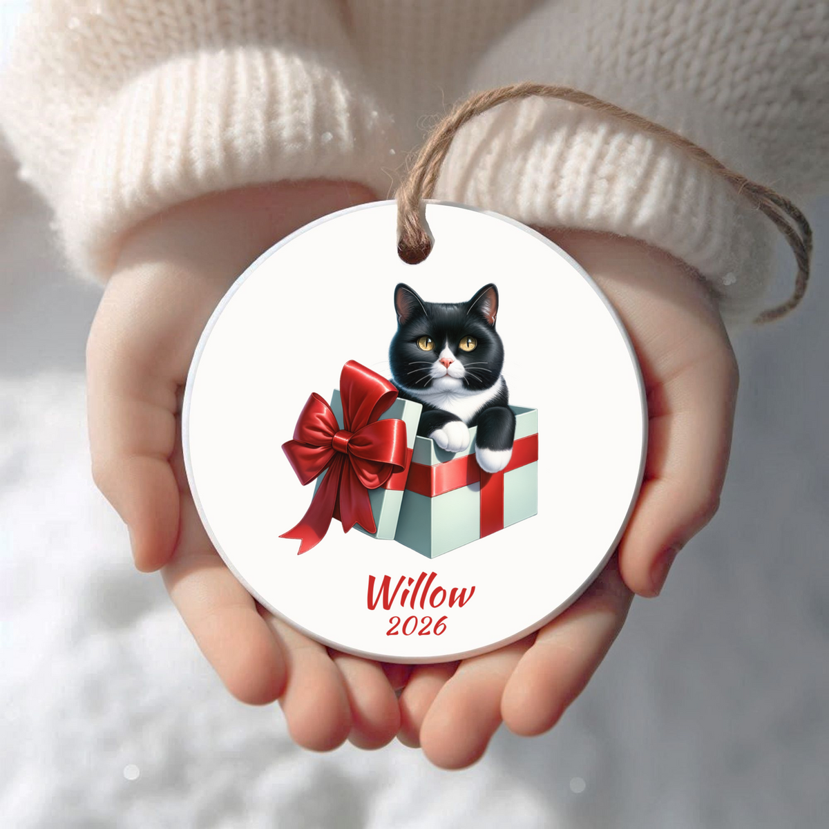 Personalized Tuxedo Cat Christmas ornament held in cupped hands