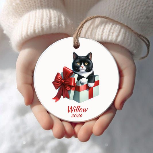 Personalized Tuxedo Cat Christmas ornament held in cupped hands