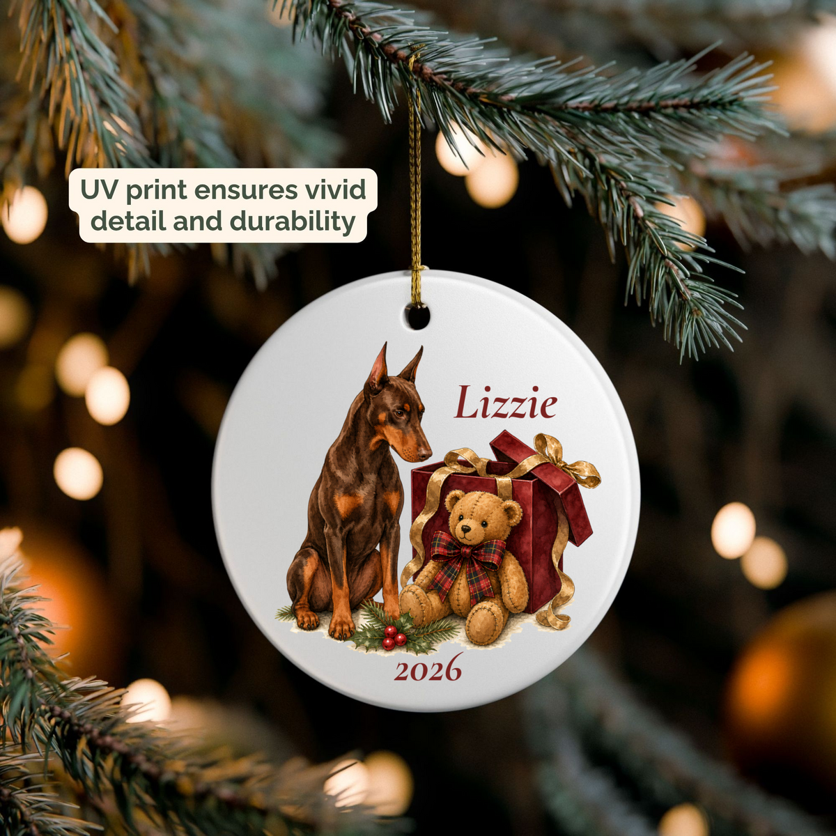 Hand holding a personalized Doberman Pinscher (Red) ceramic ornament beside a Christmas tree