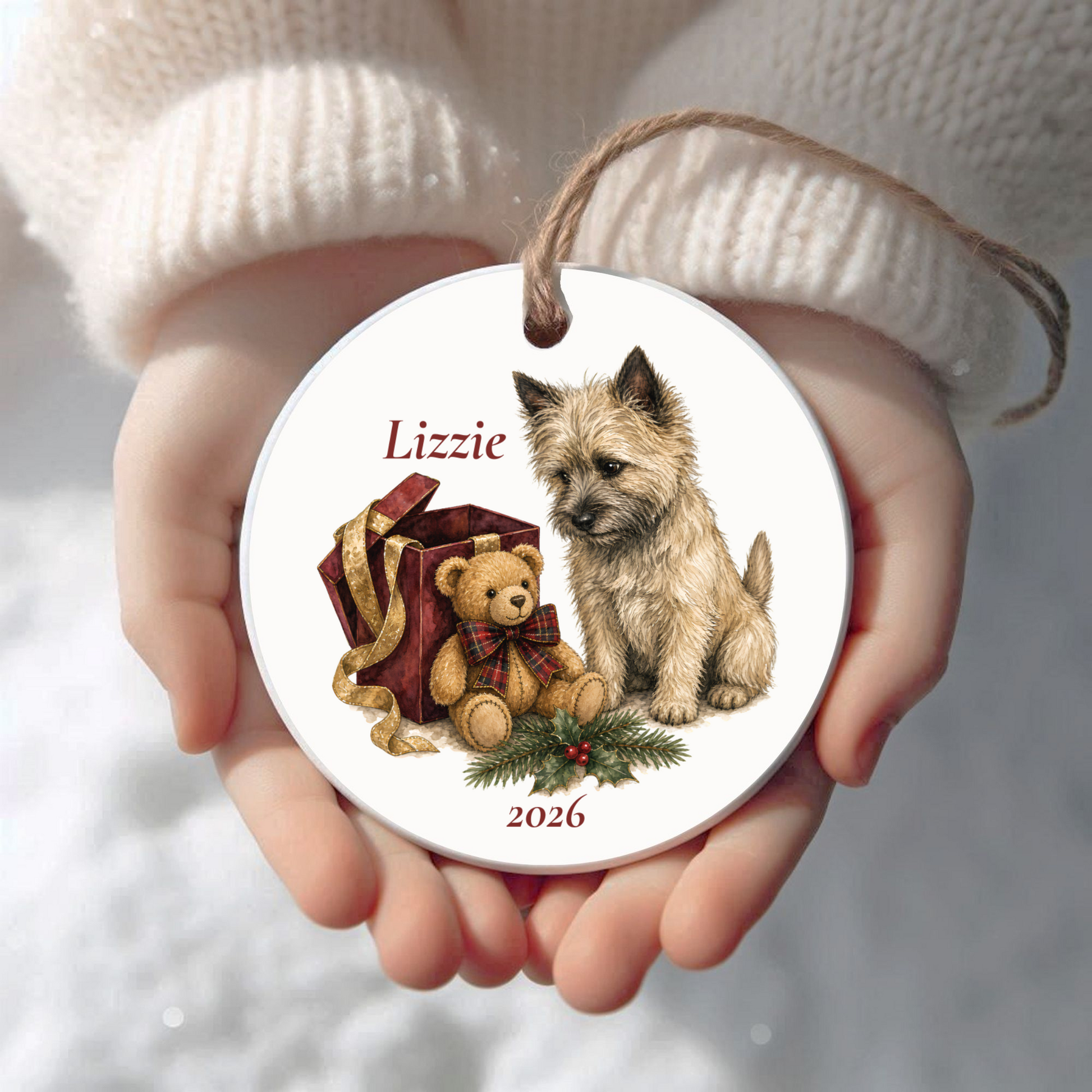 Personalized Cairn Terrier Christmas ornament held in cupped hands