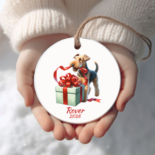 Personalized Airedale Terrier Christmas ornament held in cupped hands