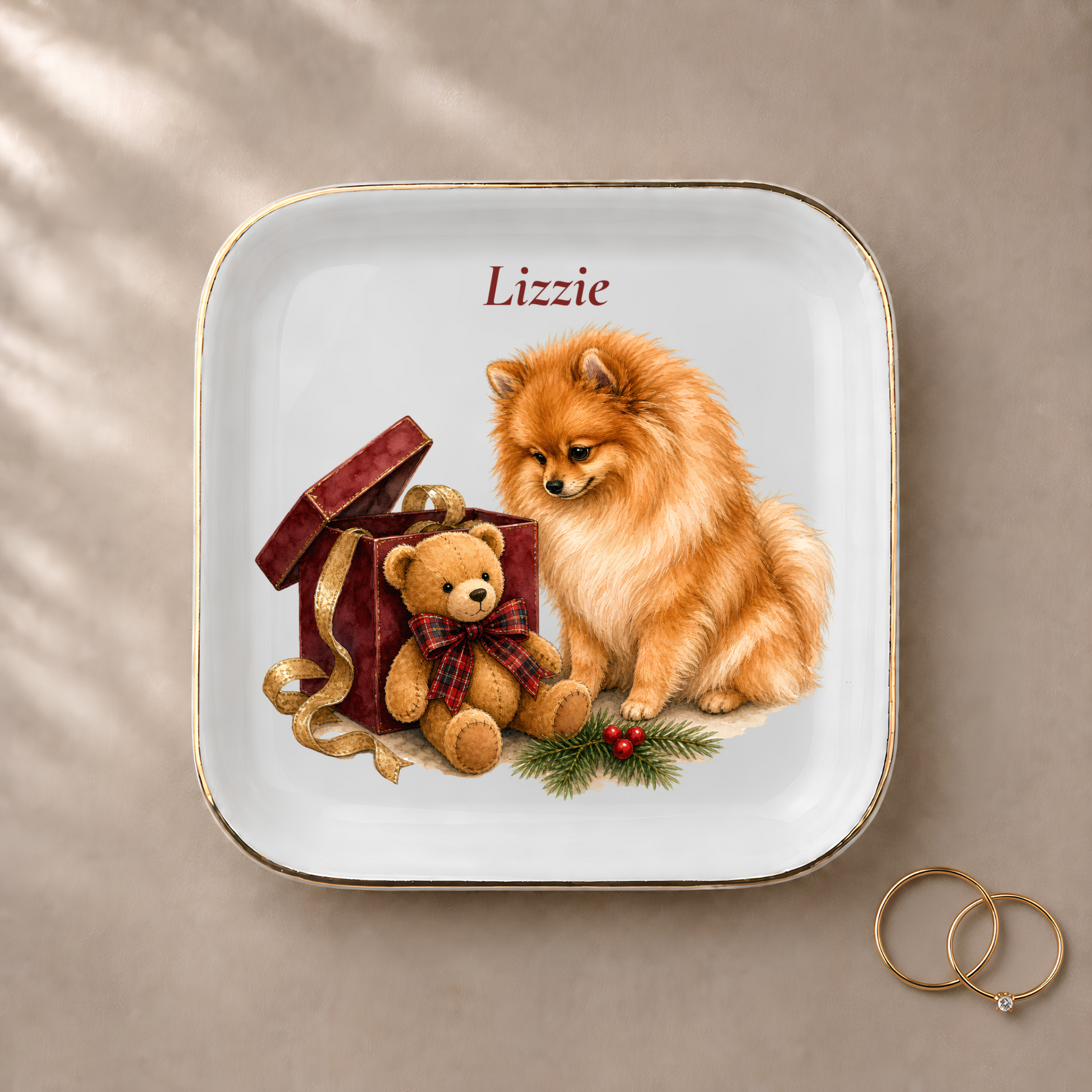Pomeranian jewelry dish styled with gold rings and a personalized name