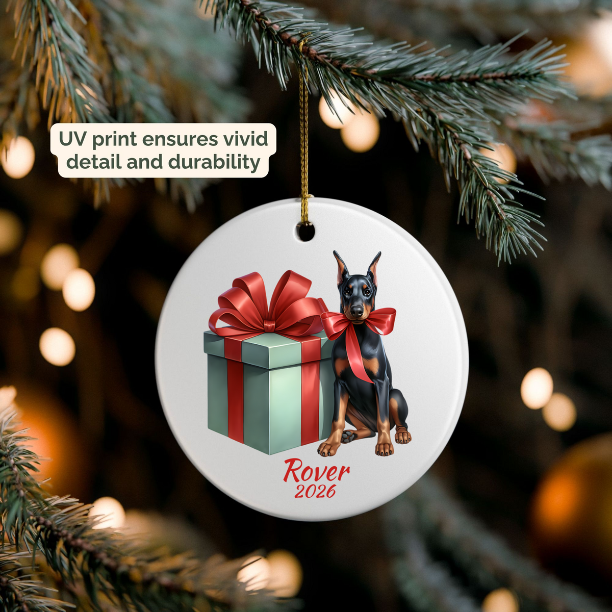 Personalized black and tan Doberman Pinscher ornament hanging on a lit Christmas tree