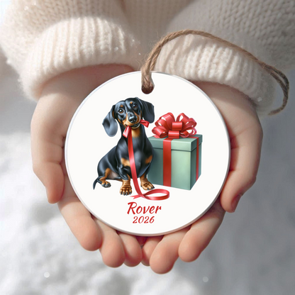 Personalized black and tan Dachshund Christmas ornament held in cupped hands