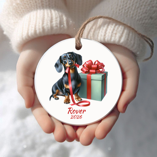 Personalized black and tan Dachshund Christmas ornament held in cupped hands