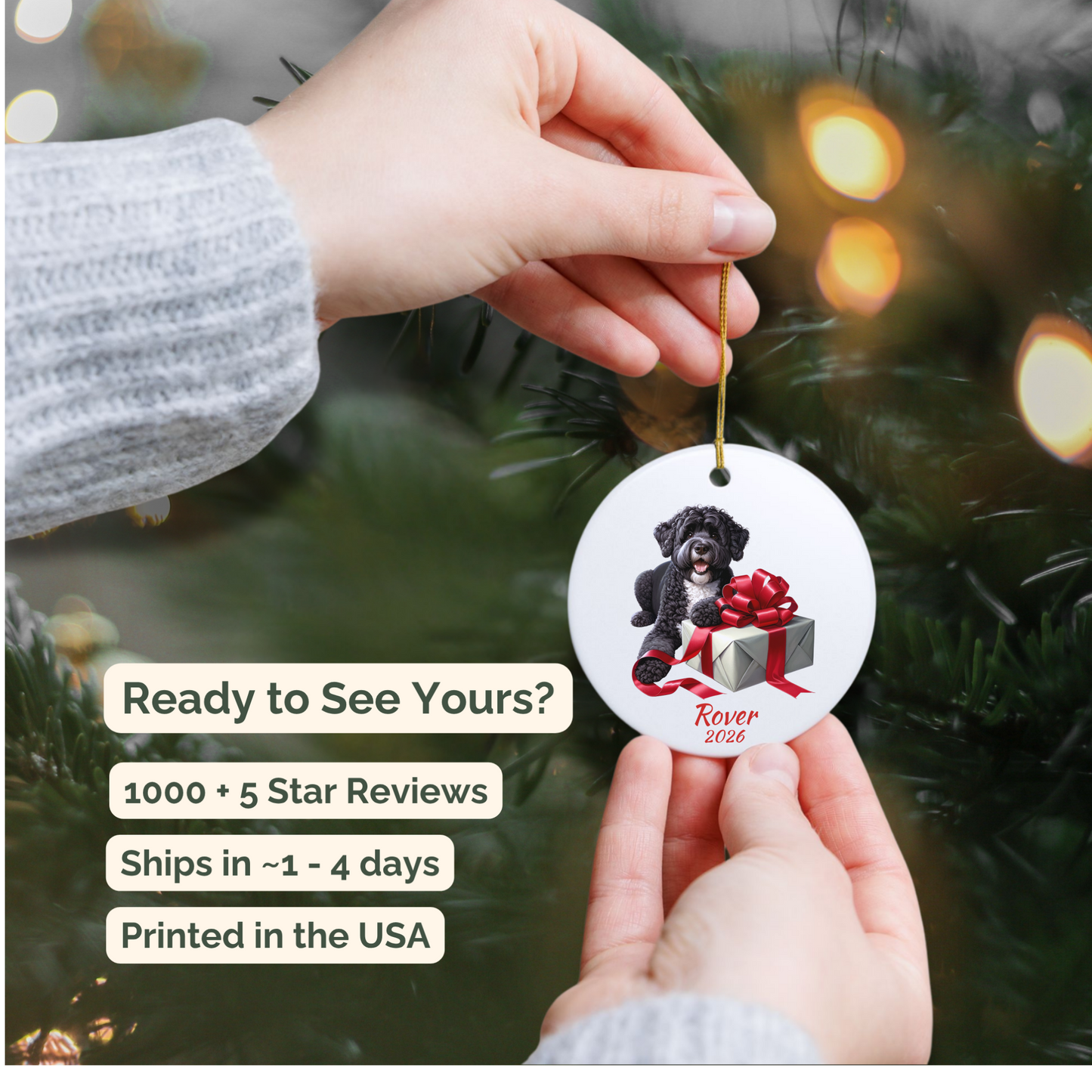 Hand holding a personalized Portuguese Water Dog ceramic ornament beside a Christmas tree