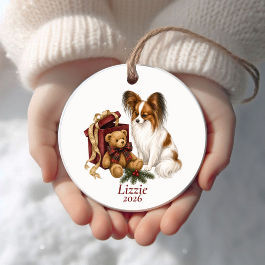 Personalized Papillon Christmas ornament held in cupped hands