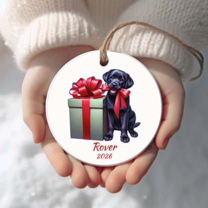 Personalized black Labrador Retriever Christmas ornament held in cupped hands