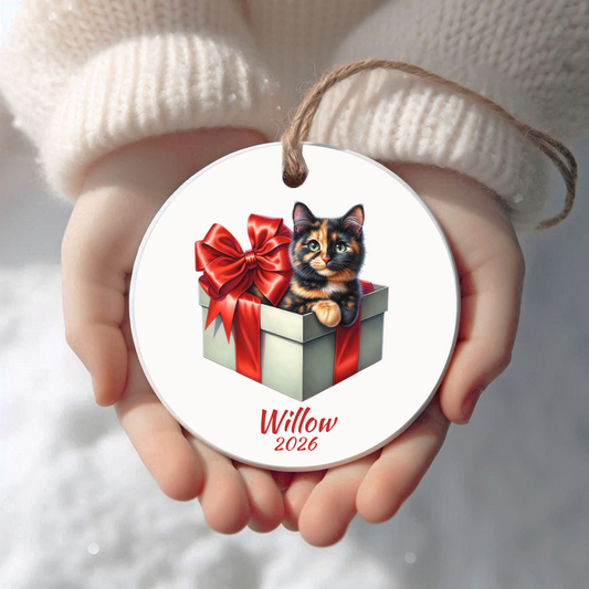 Personalized Tortie Cat Christmas ornament held in cupped hands