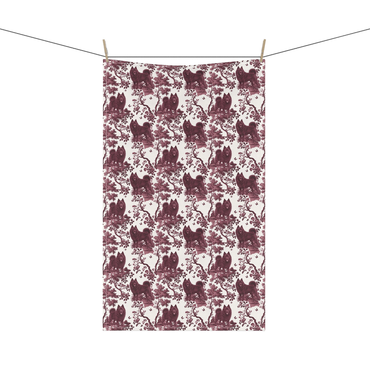Schipperke Tea Towel with cranberry toile design, hanging from a clothesline, showing the full repeating design.