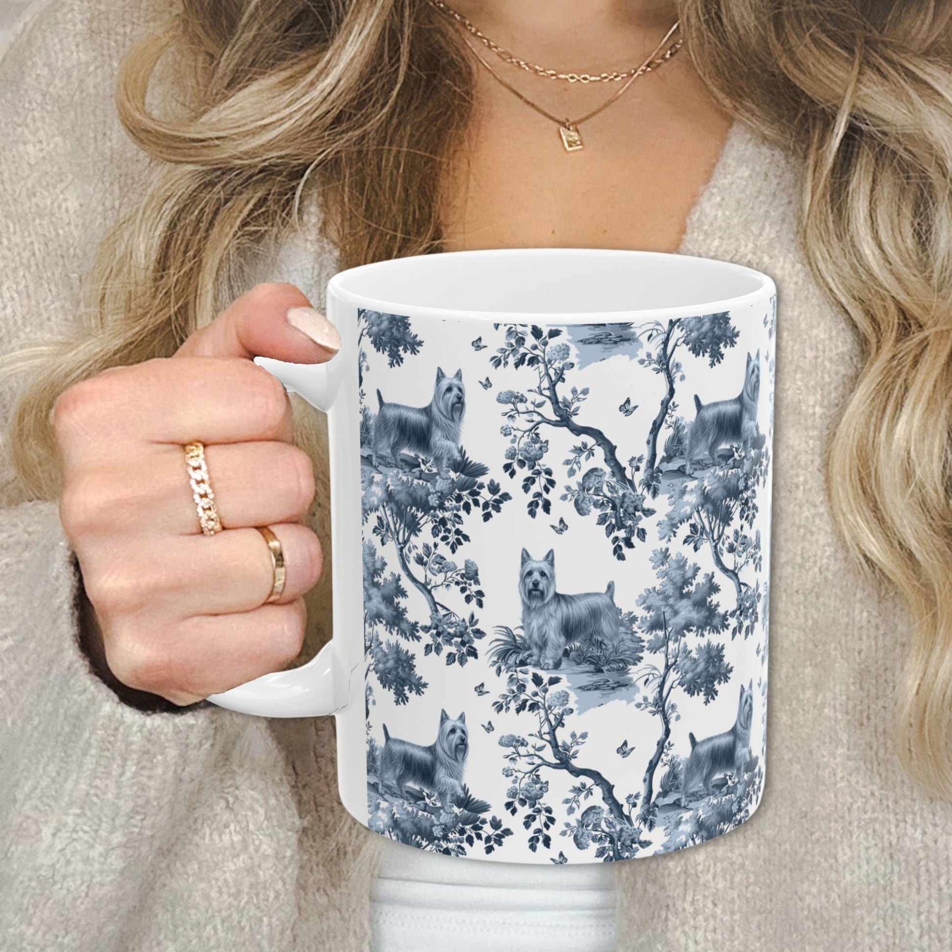 Blue toile Silky Terrier coffee cup against a cozy beige sweater