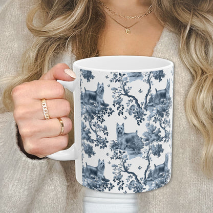 Blue toile Silky Terrier coffee cup against a cozy beige sweater