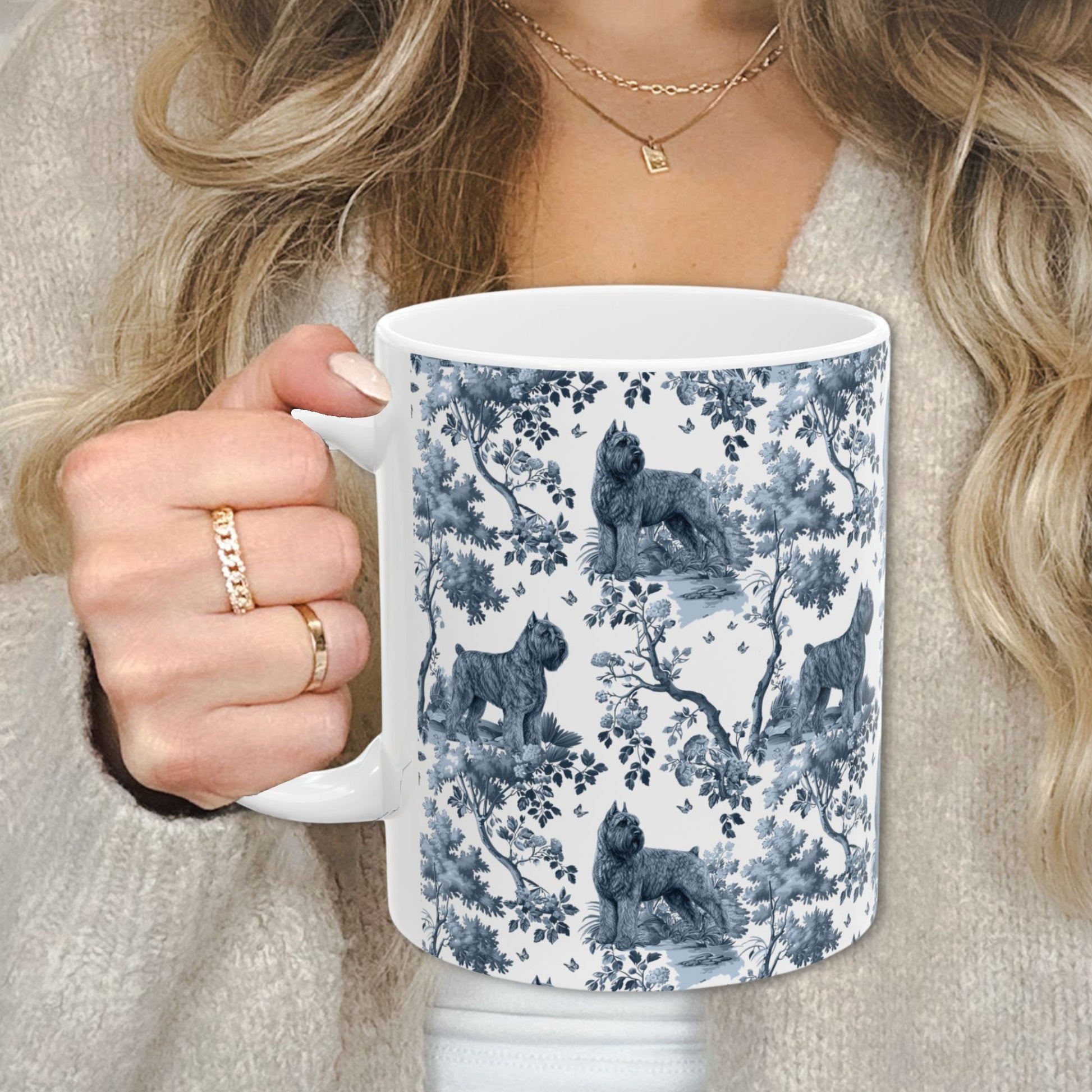 Blue toile Bouvier des Flandres coffee cup against a cozy beige sweater