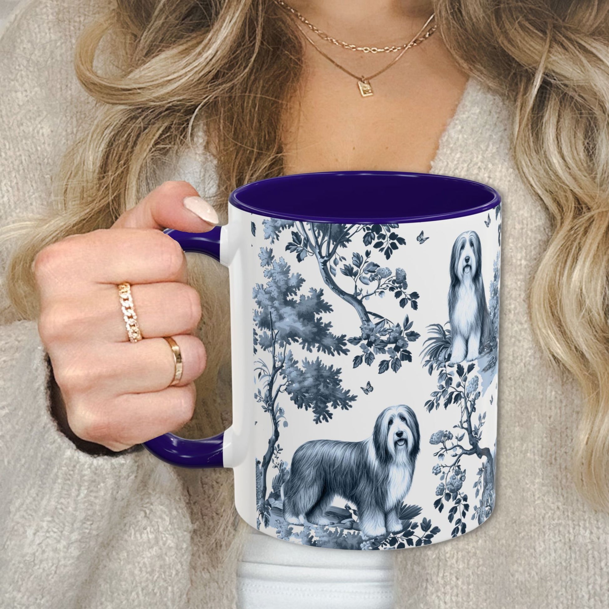 Blue toile Bearded Collie coffee cup against a cozy beige sweater