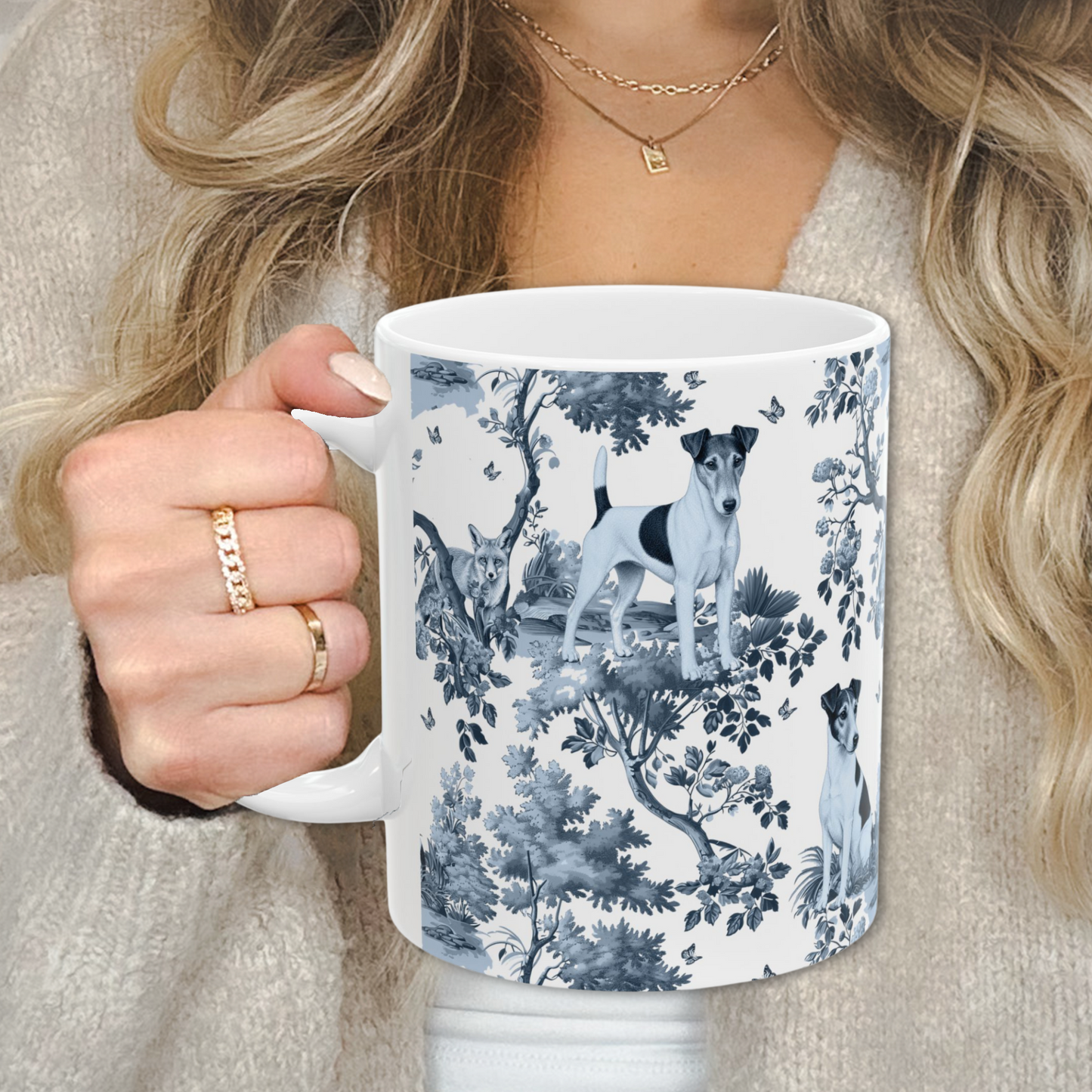 Japanese Chin blue toile white handle mug held by a person in a beige sweater