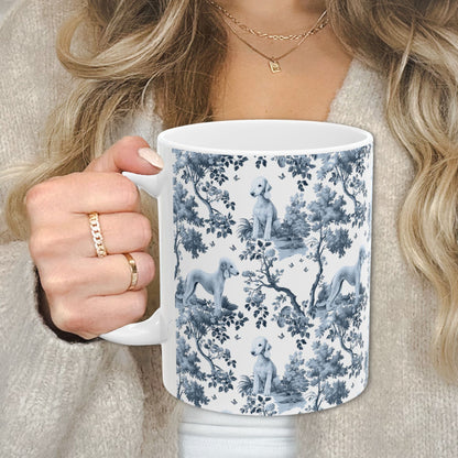 Blue toile Bedlington Terrier coffee cup against a cozy beige sweater