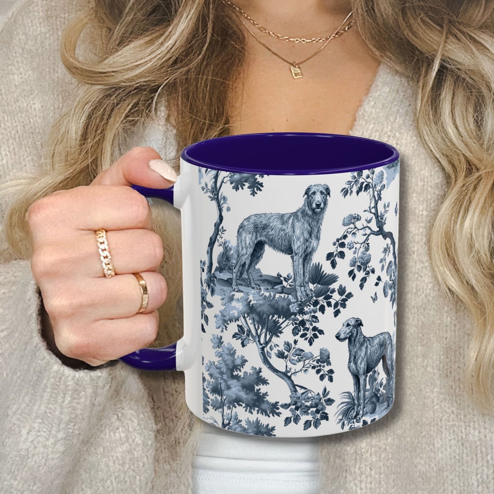 Blue toile Scottish Deerhound coffee cup against a cozy beige sweater