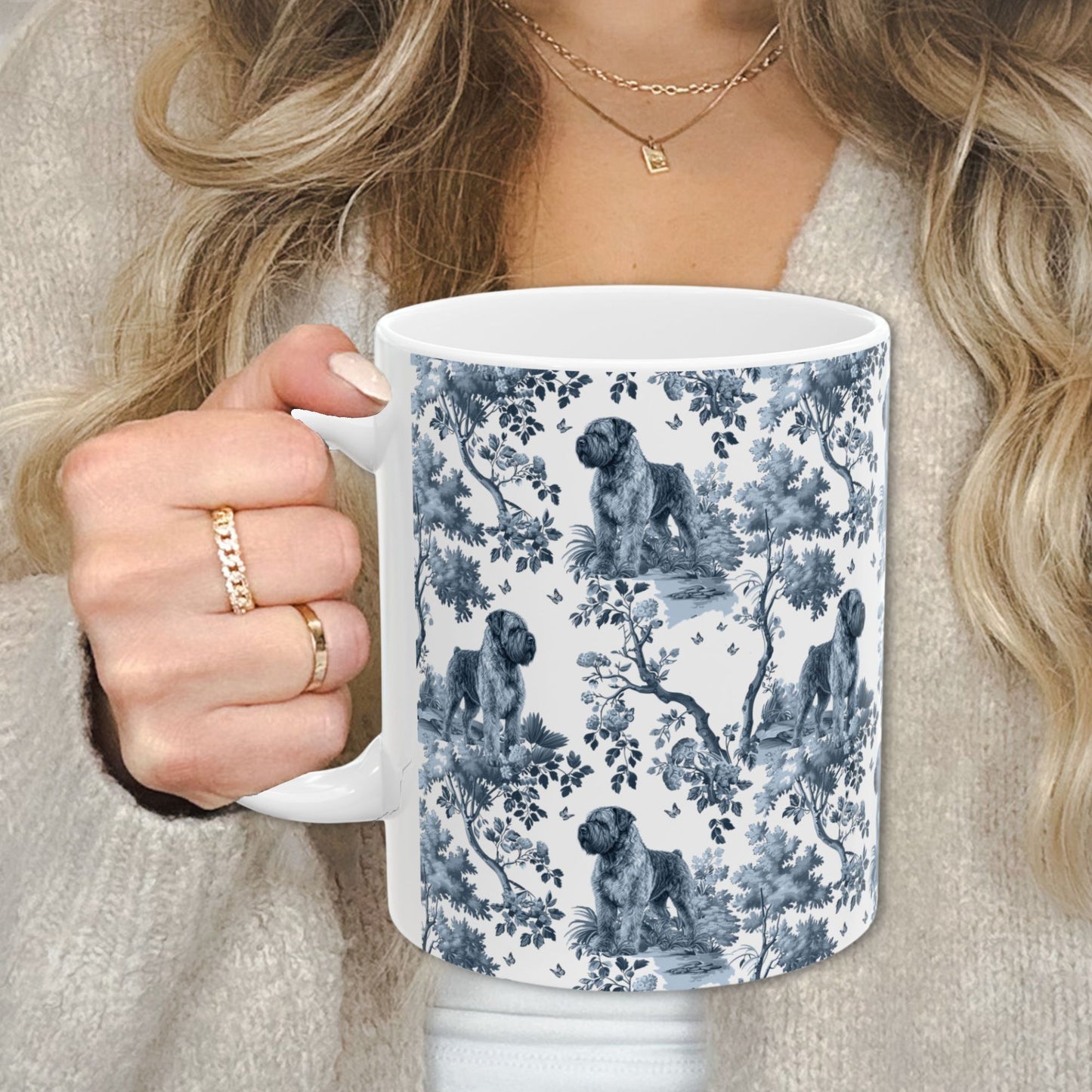 Blue toile Bouvier des Flandres coffee cup against a cozy beige sweater