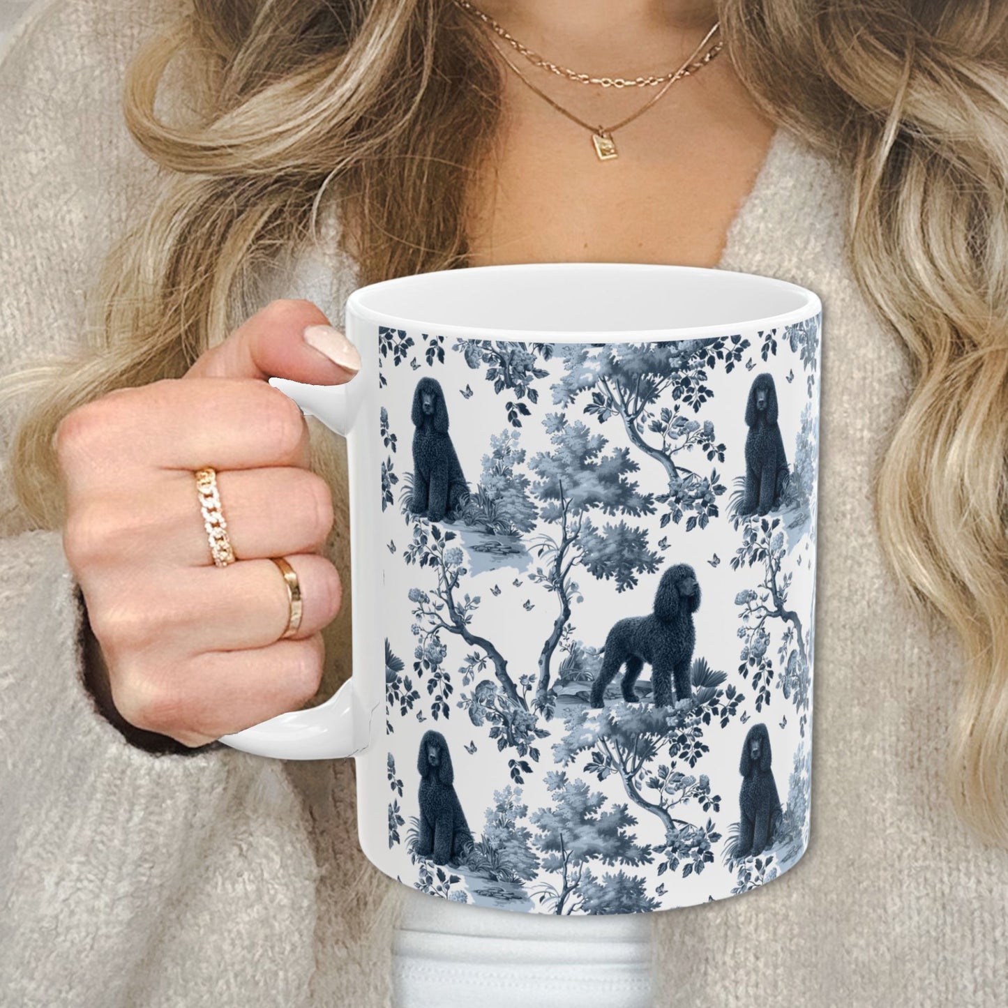 Blue toile Irish Water Spaniel coffee cup against a cozy beige sweater