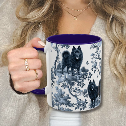 Blue toile Schipperke coffee cup against a cozy beige sweater