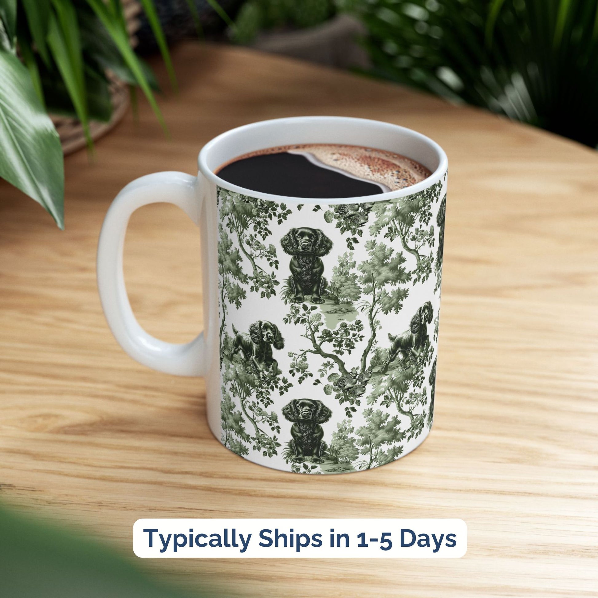Sage green toile Boykin Spaniel coffee cup styled on a wooden board in a festive setting