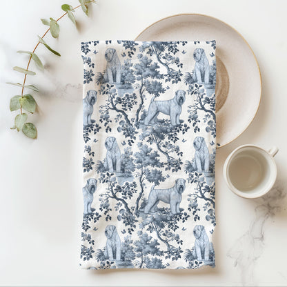 Soft Coated Wheaten Terrier Tea Towel with blue toile design, folded beside a plate and cup.