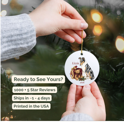 Hand holding a personalized Smooth Collie ceramic ornament in front of a Christmas tree