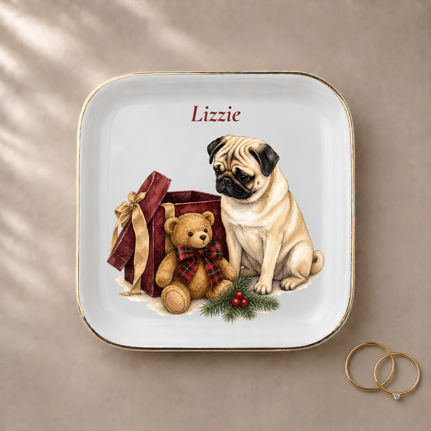 Pug jewelry dish styled with gold rings and a personalized name