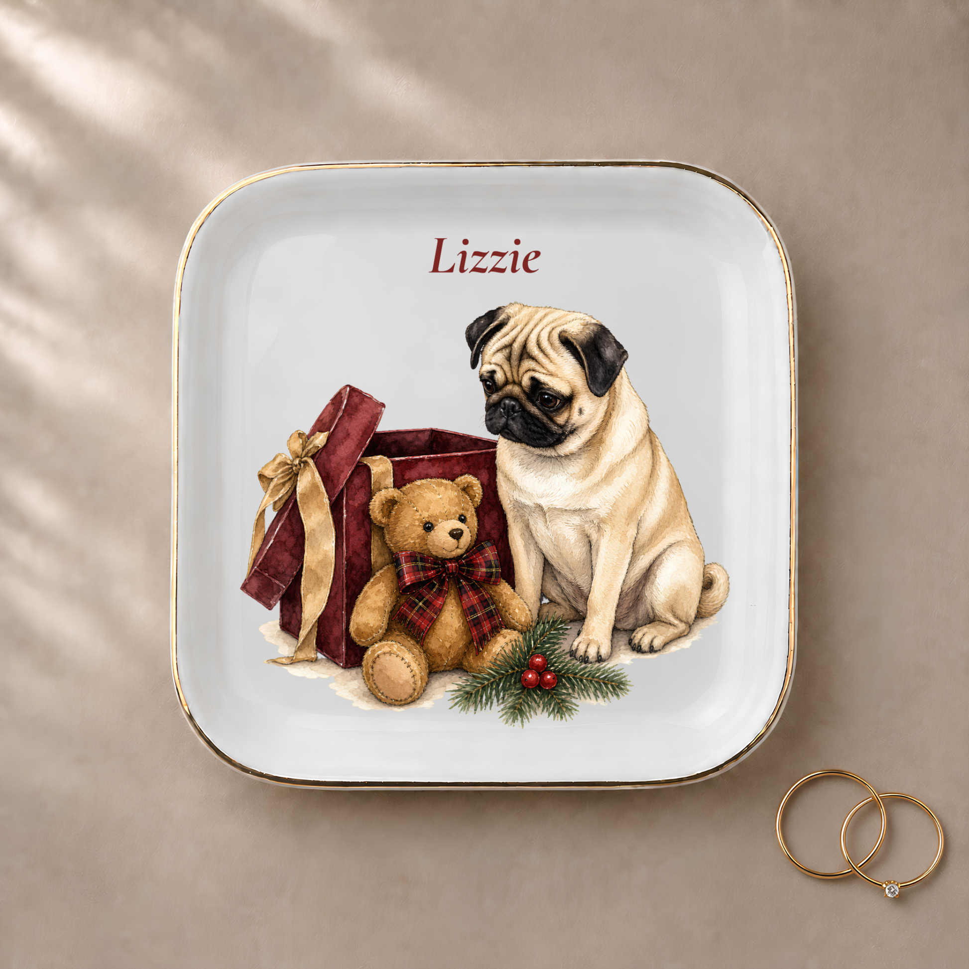 Pug jewelry dish styled with gold rings and a personalized name