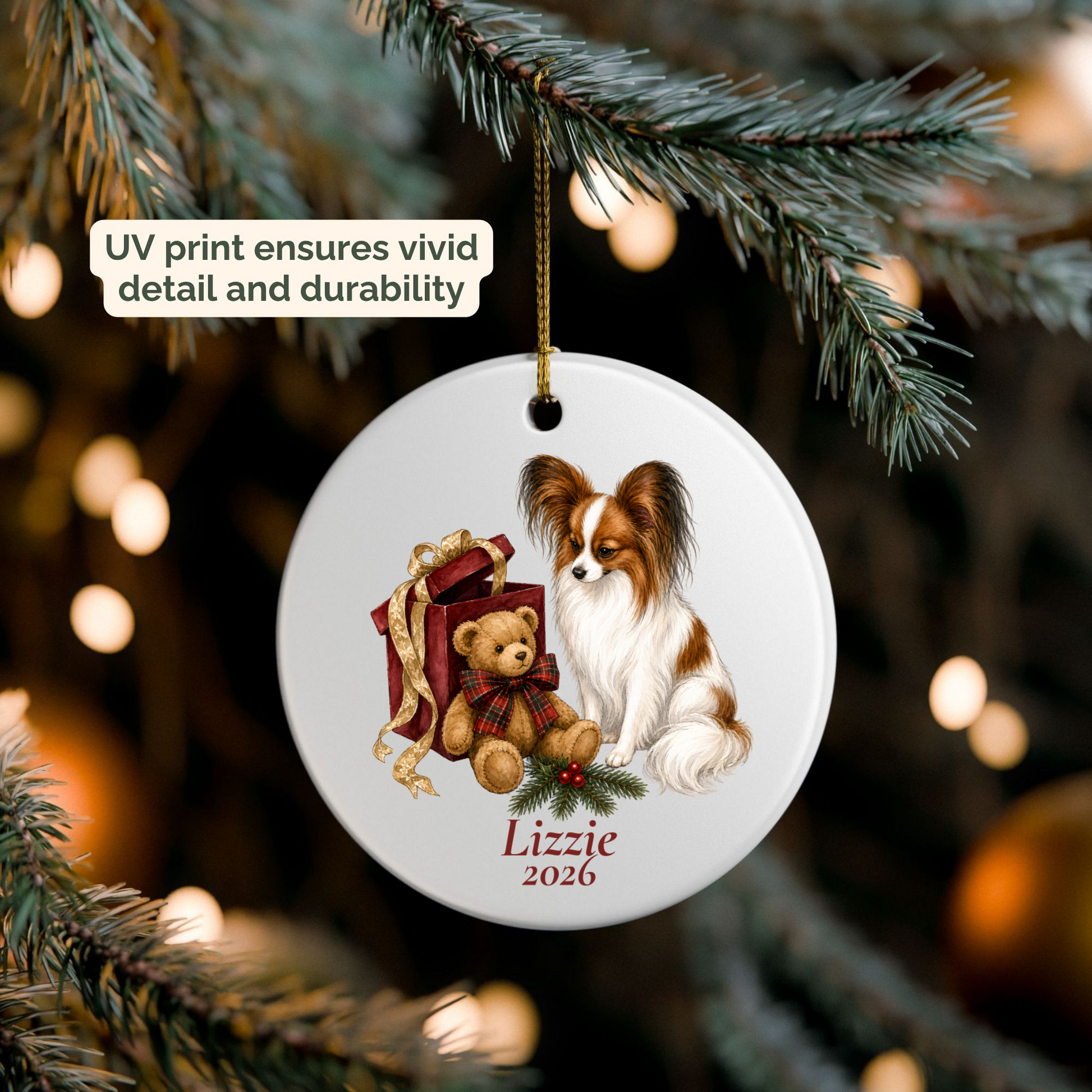 Personalized Papillon ornament hanging on a lit Christmas tree