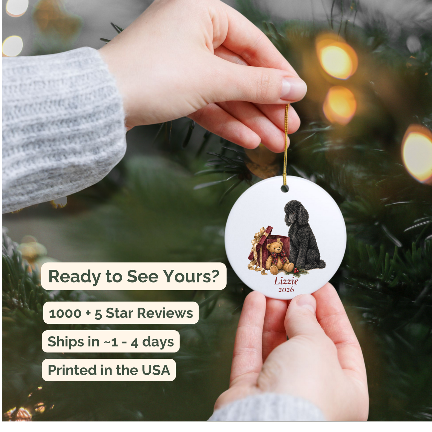 Hand holding a personalized Standard Poodle (Black) ceramic ornament beside a Christmas tree