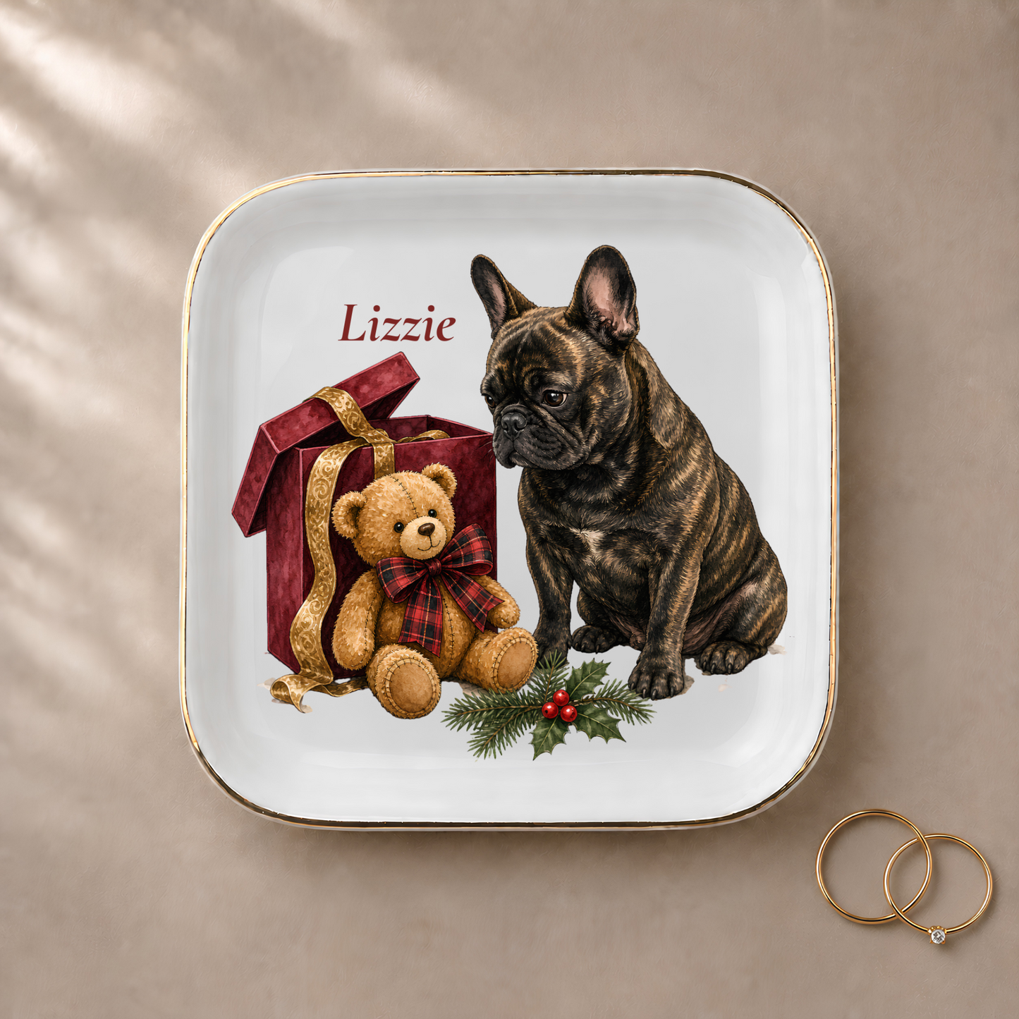 French Bulldog jewelry dish styled with gold rings and a personalized name