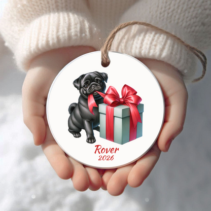 Personalized black Pug Christmas ornament held in cupped hands