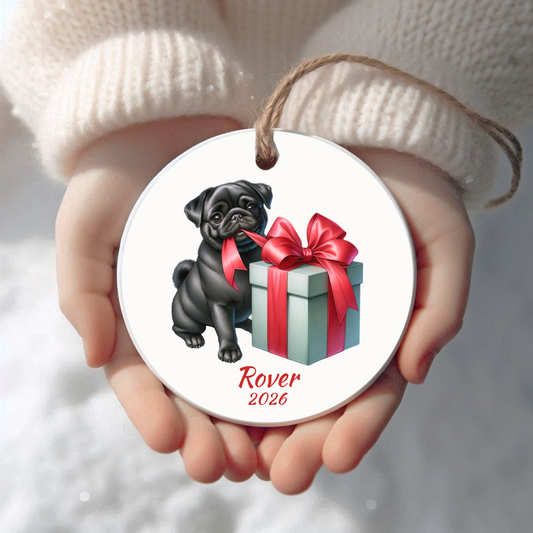 Personalized black Pug Christmas ornament held in cupped hands