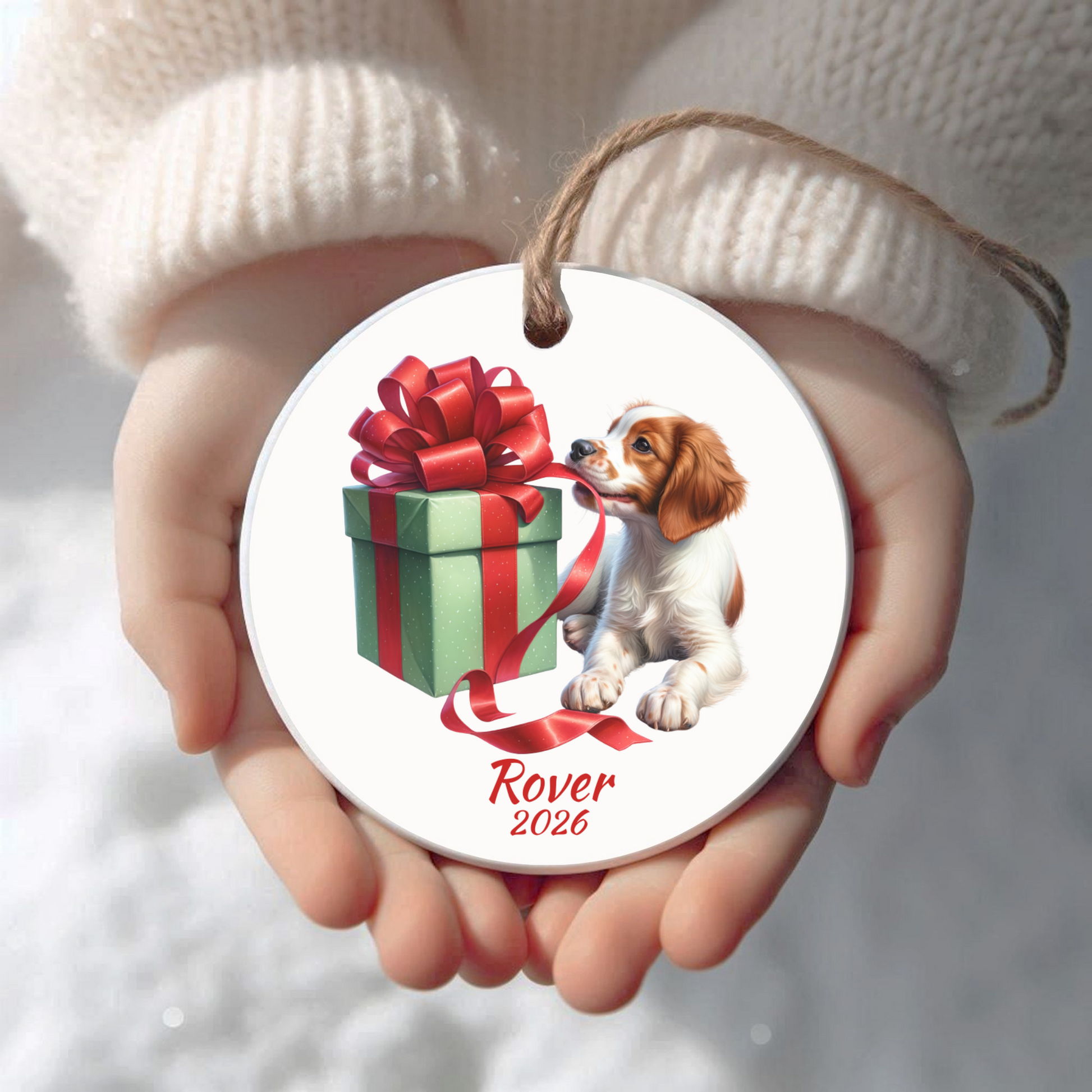 Personalized Brittany Spaniel Christmas ornament held in cupped hands