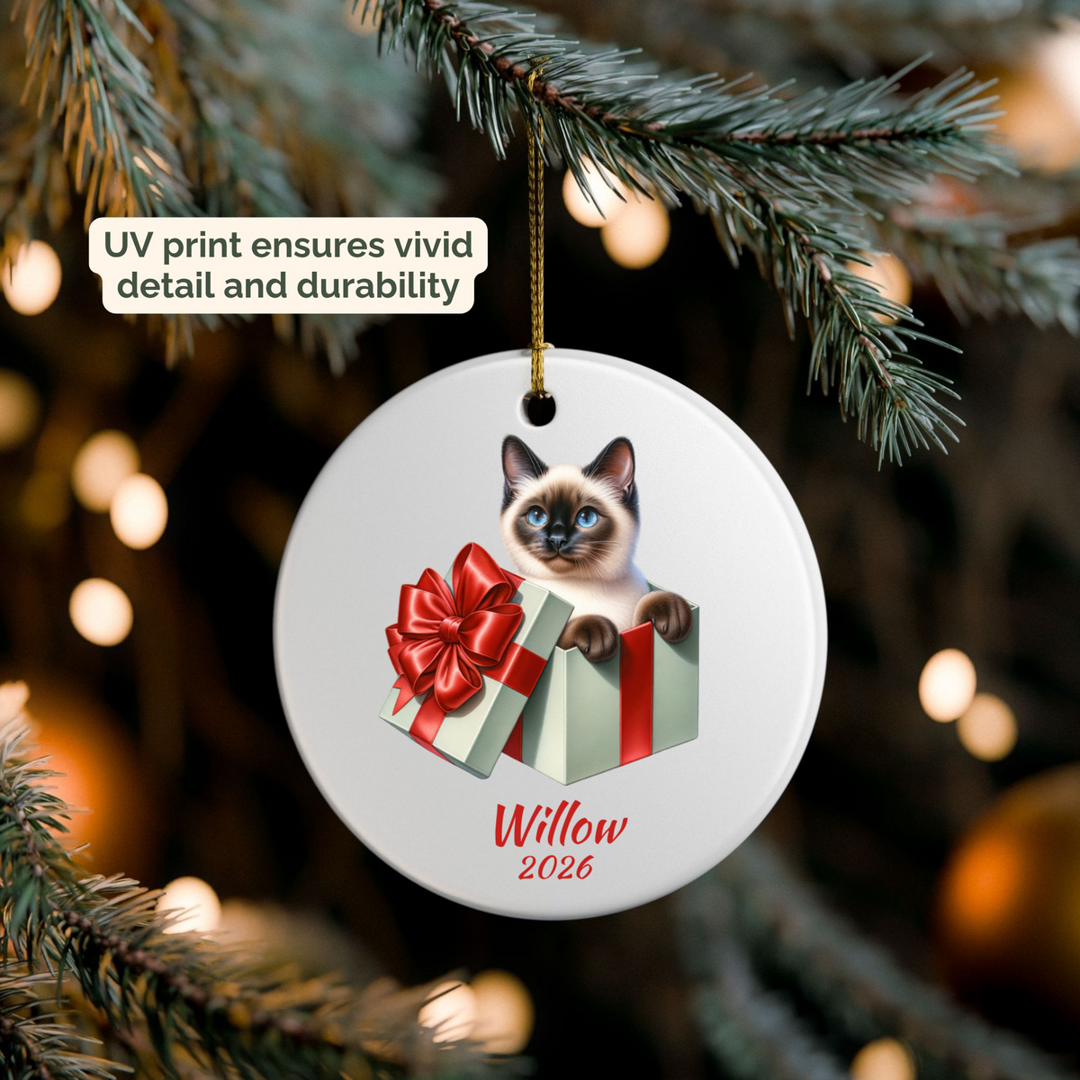 Personalized Siamese Cat ornament hanging on a lit Christmas tree