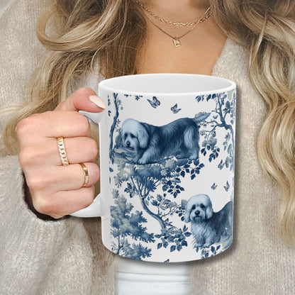 Blue toile Dandie Dinmont Terrier coffee cup against a cozy beige sweater
