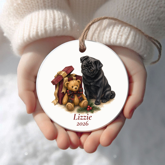 Personalized Pug (Black) Christmas ornament held in cupped hands