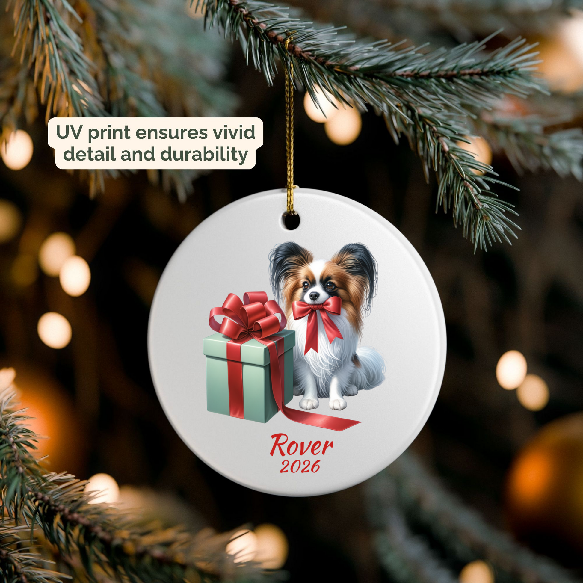 Personalized Papillon ornament hanging on a lit Christmas tree