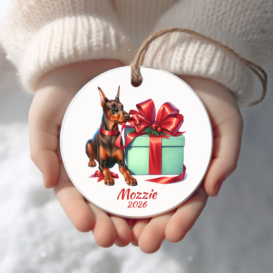 Personalized red Doberman Pinscher Christmas ornament held in cupped hands