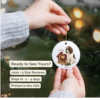 Hand holding a personalized English Springer Spaniel (Liver) ceramic ornament beside a Christmas tree