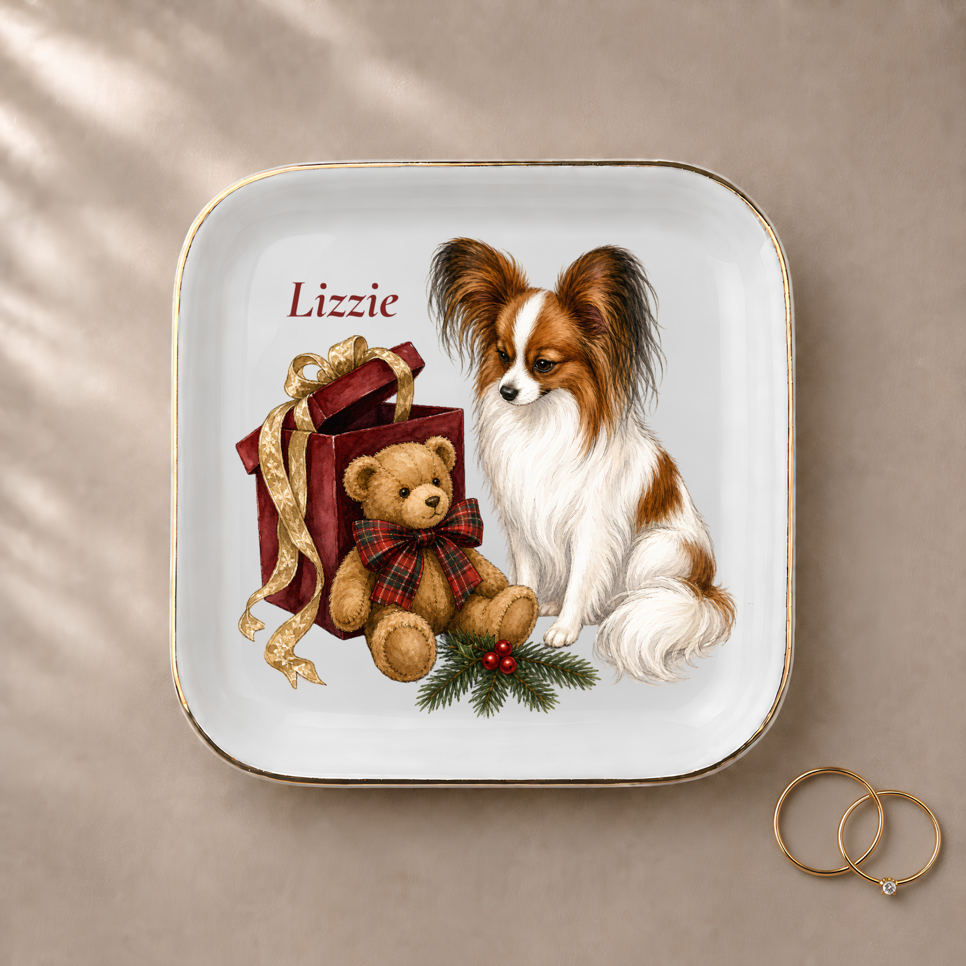 Papillon jewelry dish styled with gold rings and a personalized name