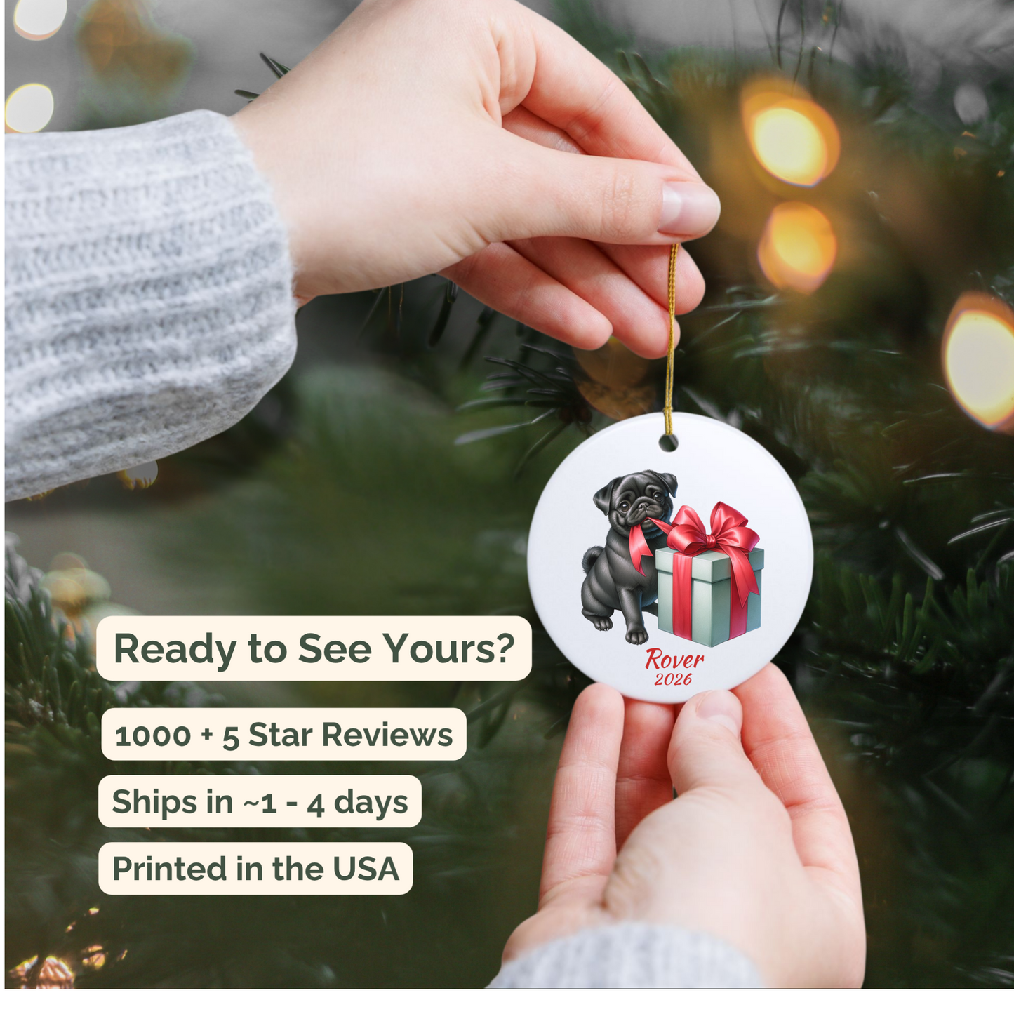 Hand holding a personalized black Pug ceramic ornament beside a Christmas tree