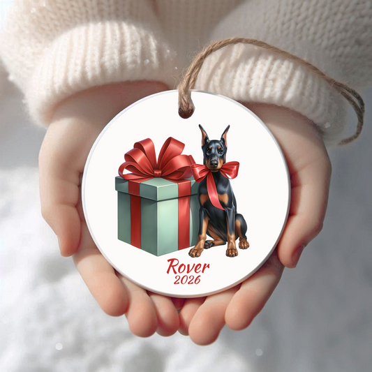 Personalized black and tan Doberman Pinscher Christmas ornament held in cupped hands